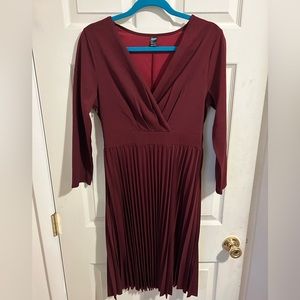 Burgundy knee length v-neck pleated dress.